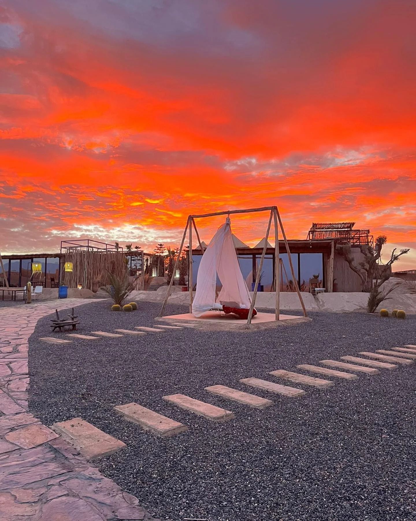 Red sunset sky over a camp in the Agafay desert