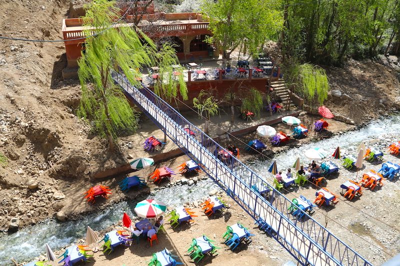 Tables set in the river and a footbridge at Setti Fatma