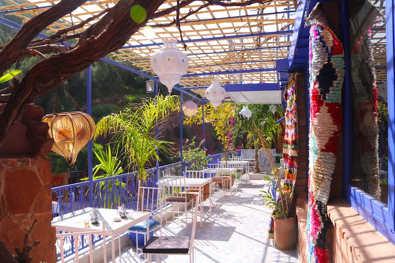 Shaded restaurant terrace decorated with lanterns and rugs